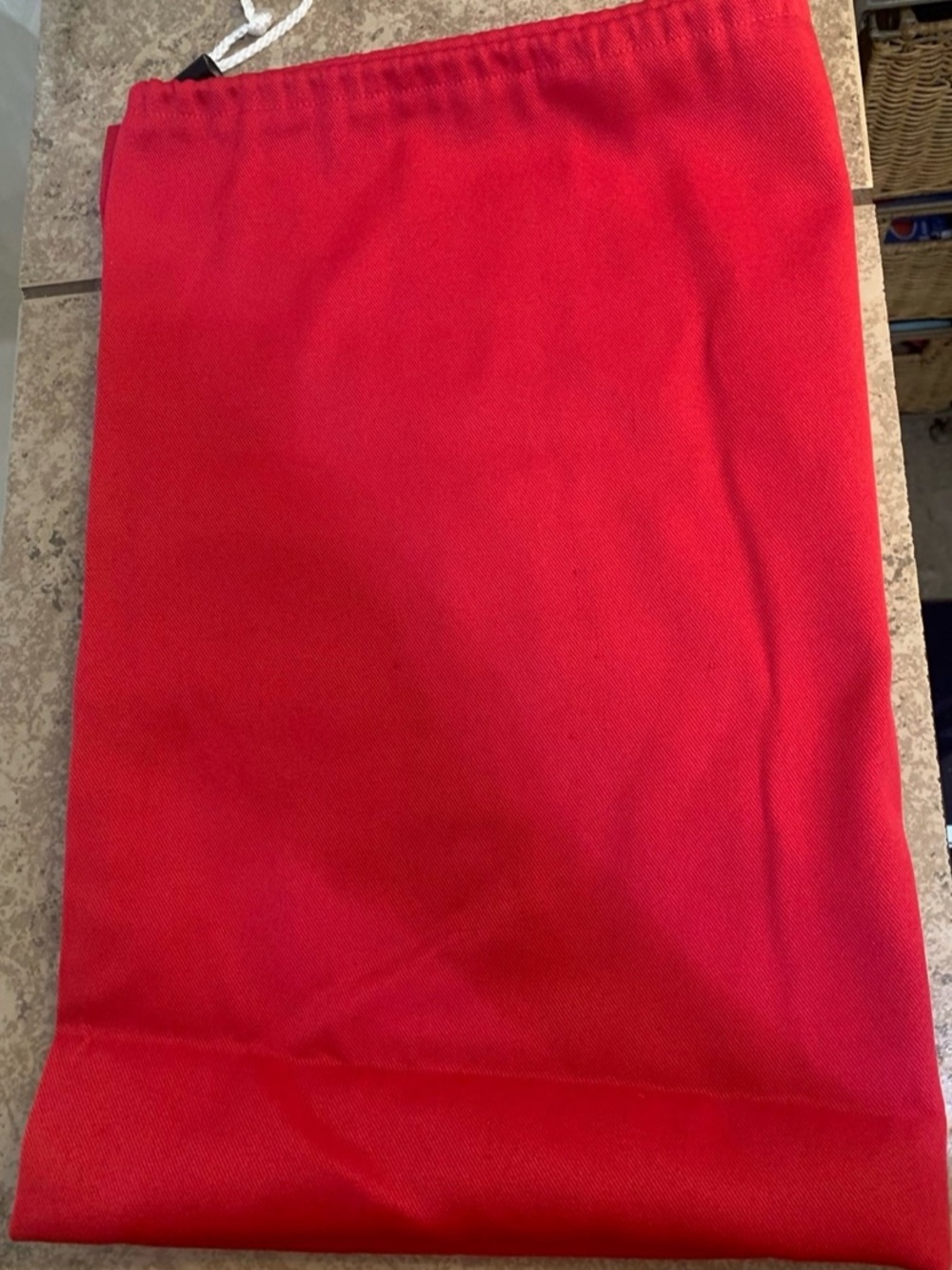 Solid Red Drawstring Laundry Bag. Made of Fabric and White drawstring closure.
